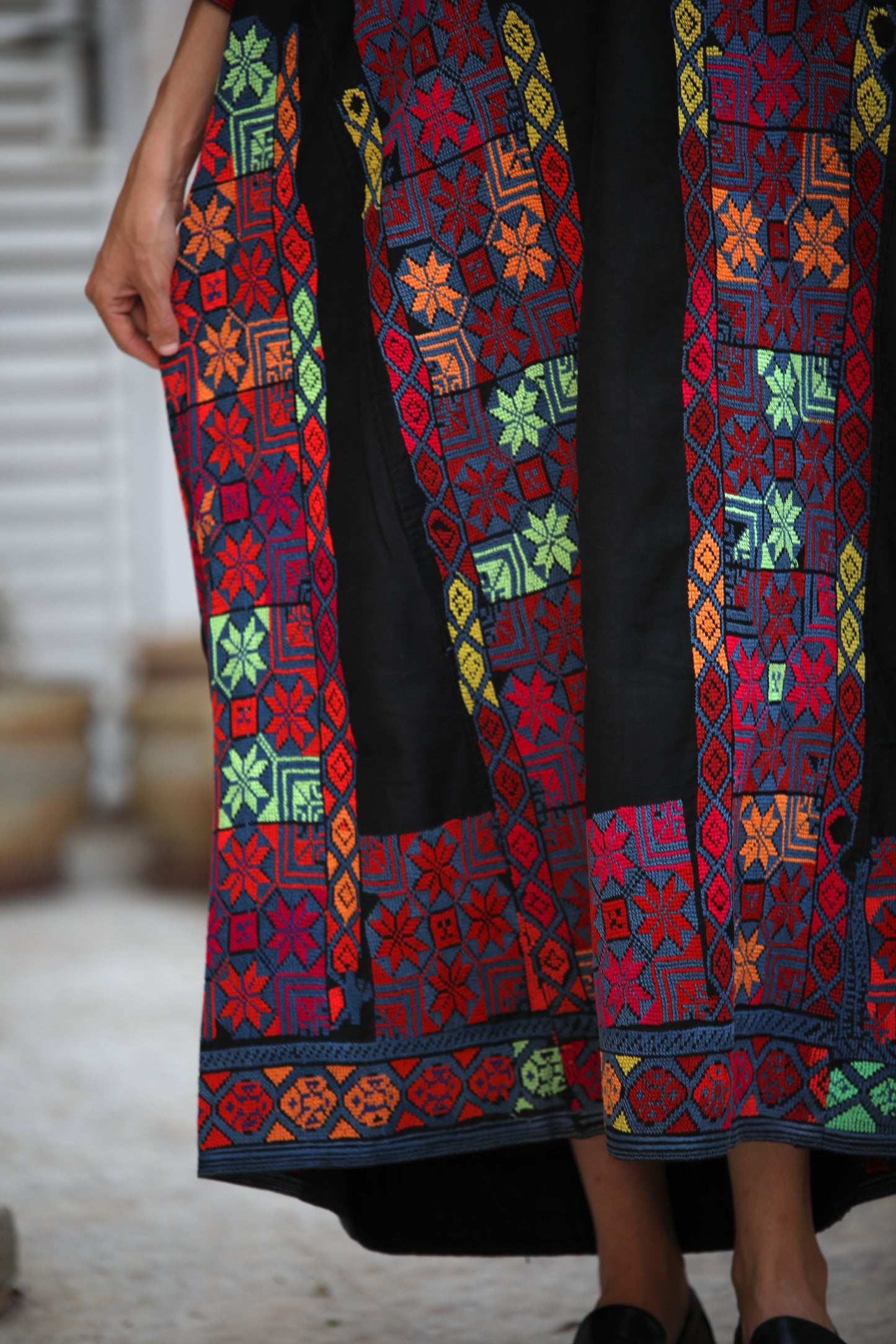 Colorful embroidered fabric with geometric patterns on a blurred background
