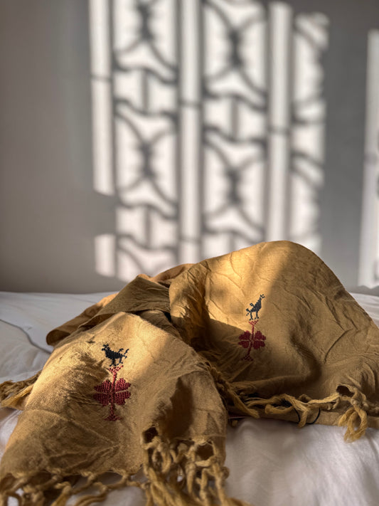 Decorative fabric with embroidered patterns on a textured wall background