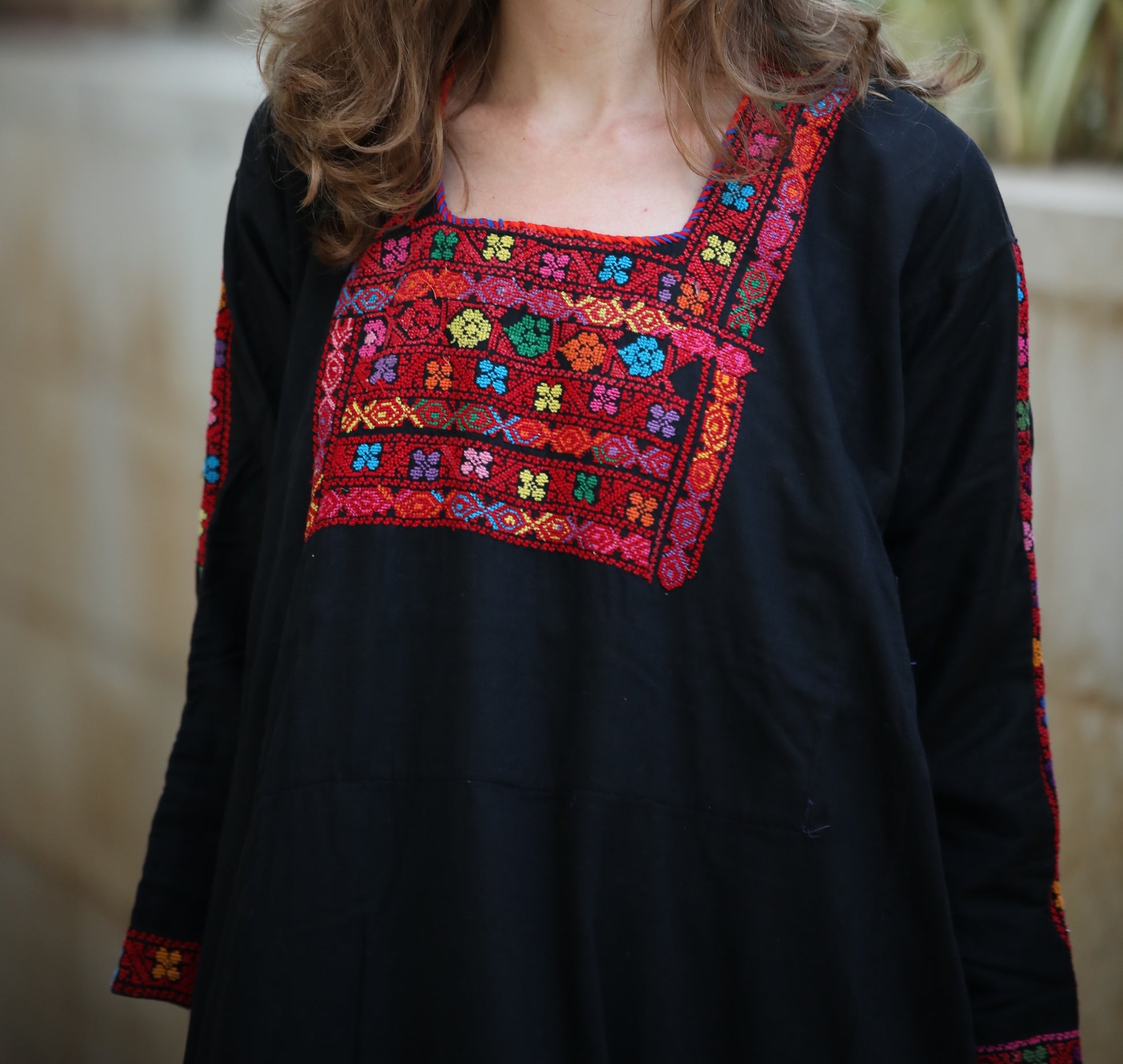 Black top with colorful embroidered neckline